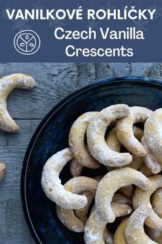 a bowl filled with powdered sugar covered pretzels on top of a wooden table