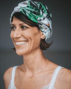 a woman wearing a green and white head wrap