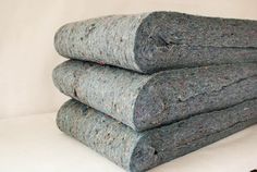 three rolled up rugs sitting on top of each other