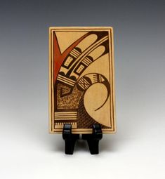 a small wooden box with an abstract painting on it