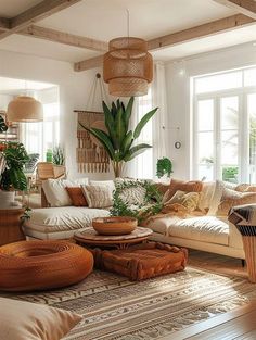 a living room filled with lots of furniture and plants on top of the couches