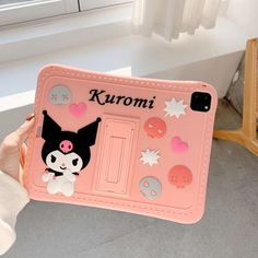 a person holding up a pink phone case with an image of a cat on it