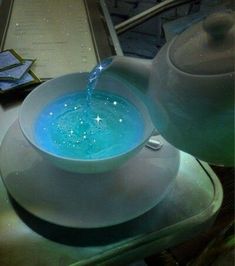 a tea pot pouring water into a bowl