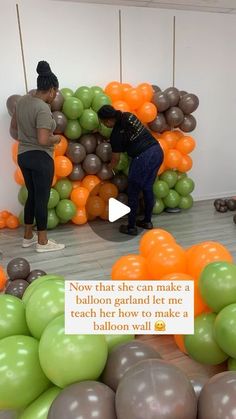 two people standing in front of balloons with the caption now that she can make a balloon garland let me teach how to take it