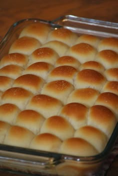 a casserole dish with rolls in it on a table