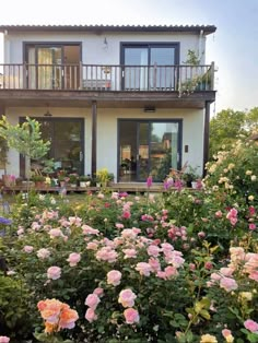 a house that has some flowers in front of it