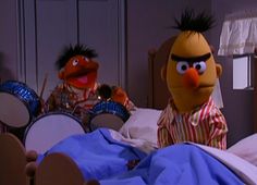 the muppets are in bed with their drums and drum set up behind them