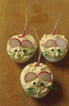 three small pieces of food with radishes in the shape of mouses on them