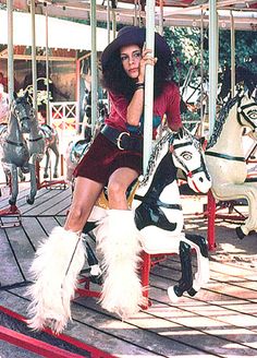 a woman sitting on top of a merry go round