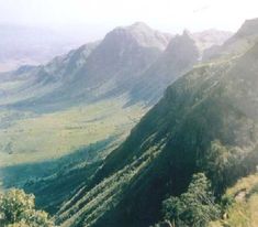 a view of mountains and valleys from the top of a hill