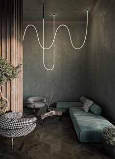 a living room filled with furniture and a chandelier hanging over the top of it