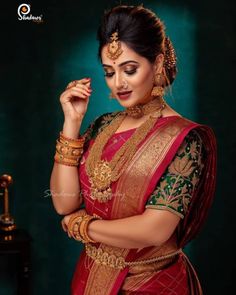 a woman in a red and gold sari