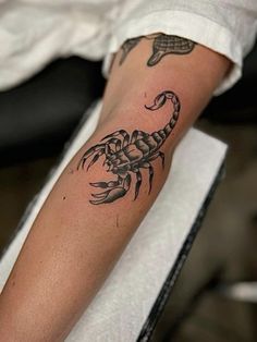 a person with a crab tattoo on their arm