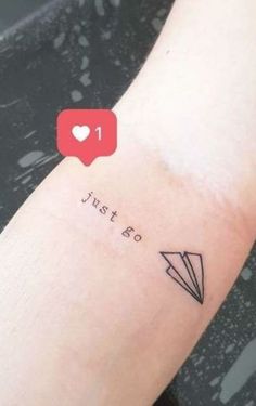 a person with a tattoo on their arm that says just go and an arrow in the middle