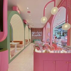 the inside of a pink and green store with lots of counter space on each side