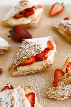 pastries with strawberries and powdered sugar on top