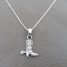 "A sweet and simple necklace with a Cowboy Boot Pendant. The pendant is made of sterling silver as well as the chain. The pendant on the necklace measures about 20mm x 10mm with bail. The chain measures 18\". Your necklace will be shipped in a gift box." Cowboy Boot Pendant, Cowboy Boot Jewelry, Cowboy Hat Necklace, Classic Sterling Silver Pendant Charm Necklace, Classic Sterling Silver Charm Necklace, Cowboy Necklace, Pretty Silver Jewelry, Western Pendant, Cowboy Boot Necklace