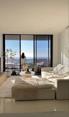 a woman standing in front of a living room window