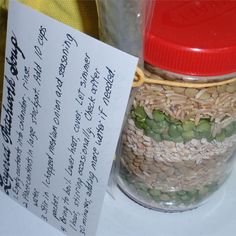 a jar filled with rice and beans next to a note