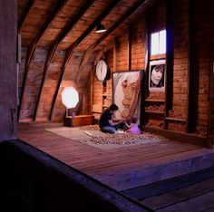 a woman sitting on top of a wooden floor