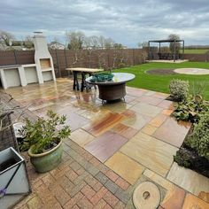 a backyard with a table and chairs in it