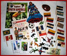 the contents of a child's book laid out on top of a bed with flags and other items