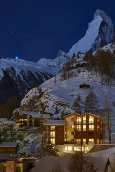 a night time view of a ski lodge in the mountains