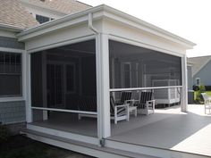 a screened porch with chairs on it