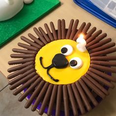 a cupcake decorated with chocolate sticks and eyes