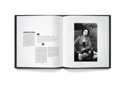 an open book with black and white photos on the pages, showing a woman sitting in a chair