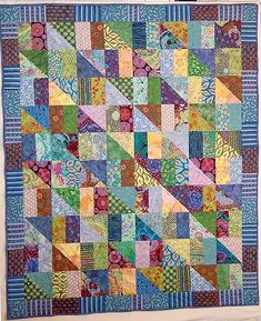 a colorful quilt hanging on the wall