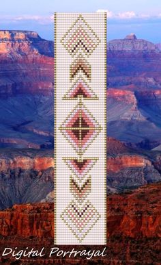 a cross stitch pattern on the side of a mountain with mountains and sky in the background