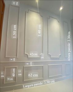 a room with white walls and measurements for the wall