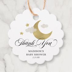 a white and gold baby shower tag with the words thank you on it