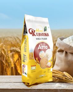 a bag of rice sitting on top of a wooden table next to a wheat field