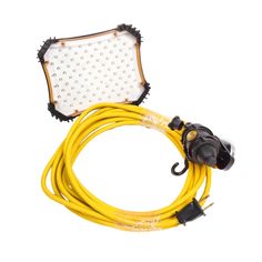 the yellow extension cord is connected to a white light on a white background with black dots