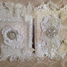 two wedding garters with white flowers and pearls on the side, one is made out of lace