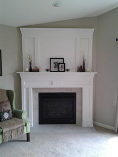 a living room with a fireplace and pictures on the mantle