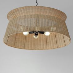 the light fixture is made from wicker and has two lights on each side of it