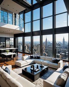 a living room filled with lots of furniture and large windows overlooking the cityscape