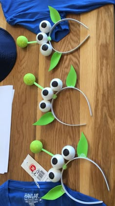 an assortment of items made to look like flowers and leaves on a wooden table top