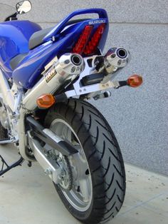 a blue motorcycle parked next to a building