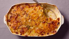 a casserole dish is shown with a spoon in it