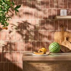 there is a watermelon and other fruits on the table