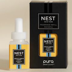 a bottle of nest perfume next to a box