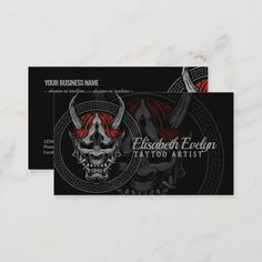 a business card with an image of a demon skull on the front and back of it