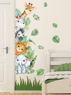 the wall decals in this children's room are painted with jungle animals and leaves