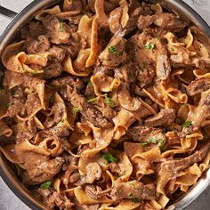 a pot filled with pasta and meat sauce