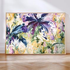 an abstract painting is displayed on the wall in front of a hardwood flooring area