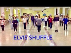 a group of people walking down a hall with the words elvis shuffle in front of them